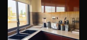 a kitchen counter with a sink and a window at Orange Place - Benson Close in Lagos +18 photos