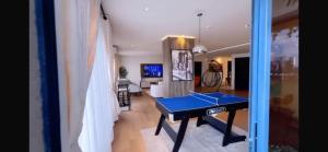 a living room with a ping pong table in it at Orange Place - Benson Close in Lagos