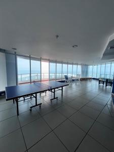 a large room with two ping pong tables in a building at Beach apartment on the seashore in Las Lajas +14 photos