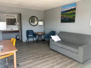 a living room with a couch and a table at Days Inn & Suites by Wyndham Needles in Needles