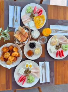 a table with plates of food on it at Albulena Hotel & Camping in Shkodër