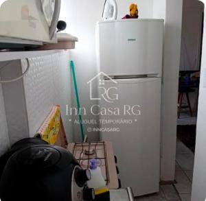 a small refrigerator in a kitchen next to a table at Apto completo centro in Rio Grande