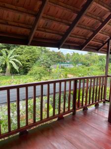 a wooden balcony with a view of a road at Ako BM homestay in Buon Ma Thuot