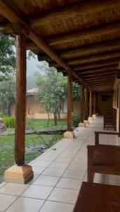 a wooden pavilion with benches in a park at Hotel Paraiso del Oso in Cerocahui