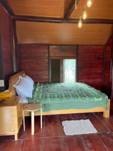 a bedroom with a bed and a wooden wall at Ako BM homestay in Buon Ma Thuot