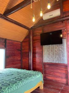 a bedroom with a bed and a flat screen tv at Ako BM homestay in Buon Ma Thuot