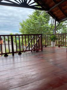 a wooden deck with a fence and a plant at Ako BM homestay in Buon Ma Thuot +10 photos