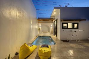 a swimming pool in the middle of a house at Villa Astella in Nusa Penida