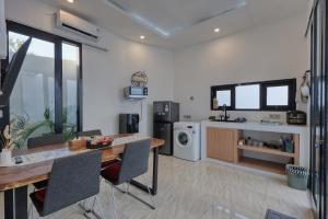 a kitchen and living room with a table and chairs at Villa Astella in Nusa Penida