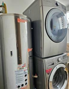 a washer and dryer next to a washing machine at 110 Loft in Cali