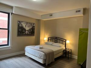 a bedroom with a bed and a window at Bauer Guesthouse in Toronto