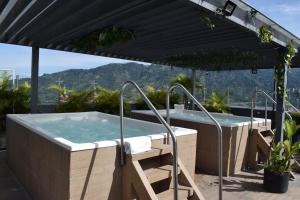 a hot tub on the roof of a house at Hotel Doral Inn in Ibagué +33 photos