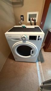 a white washing machine with a counter on top of it at Maggies Place in Ingonish