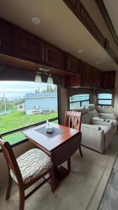 a living room with a table and a couch at Maggies Place in Ingonish