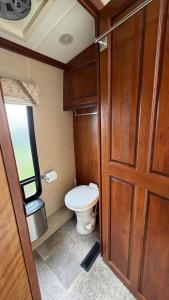 a small bathroom with a toilet and a door at Maggies Place in Ingonish +14 photos