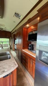 a kitchen with wooden cabinets and a stainless steel appliances at Maggies Place in Ingonish