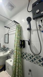 a bathroom with a shower curtain and a sink at Mamma Rose Hotel in Legazpi +25 photos