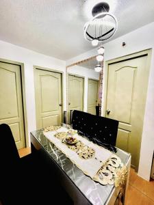 a dining room with a table with a table cloth at 2BR Condo with pool at Sorrento Oasis Pasig in Manila
