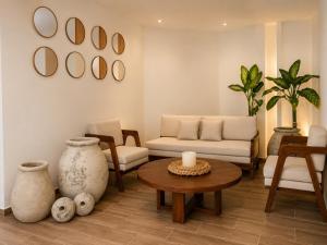 a living room with a couch and a table at Magico s apartments in Playa del Carmen +17 photos