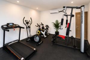 a gym with several exercise equipment in a room at Magico s apartments in Playa del Carmen