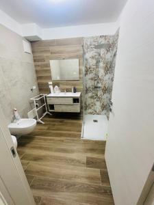 a bathroom with a sink and a shower and a toilet at Al Vicolo in Telve