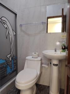 a bathroom with a toilet and a sink at CASA Sebastián in Puerto Baquerizo Moreno +11 photos