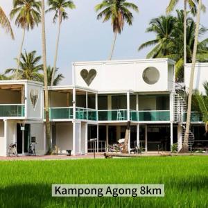 a white house with palm trees in front of it at 4B 3R Cozy Spacious Near Dewan Millenium Fully Aircond in Kepala Batas