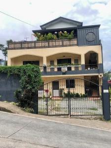 a building with a balcony with plants on it at 2 Bedrooms with free parking in Baguio