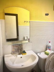 a bathroom with a sink and a mirror and a toilet at 2 Bedrooms with free parking in Baguio +13 photos