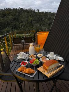 a black table with food on top of a deck at Cabana Veneza in Santa Teresa