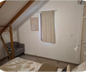 a room with a bed and a chair and a window at Chalet "Le Boisé" in Les Abymes +13 photos