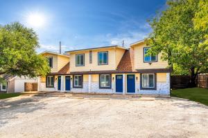 a large house with blue doors on a driveway at Spectacular Austin SoCo Townhome in Austin