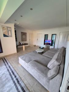 a living room with a couch and a tv at Rabat hassan in Rabat