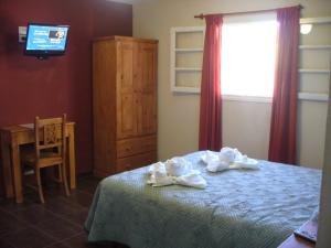 Un pat sau paturi într-o cameră la Hosteria Nuevo Sol