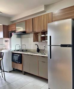 a kitchen with a stainless steel refrigerator and wooden cabinets at Alojamiento Center in Barraquero