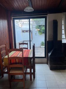 a dining room with a table and a stove at disfruta tu estadía in Salto