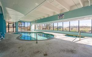 an empty building with a large swimming pool at Beachfront Bliss 3BR Oceanfront Condo with Pool and Hot Tub in Myrtle Beach