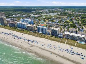 an aerial view of a beach with people and buildings at Beachfront Bliss 3BR Oceanfront Condo with Pool and Hot Tub in Myrtle Beach