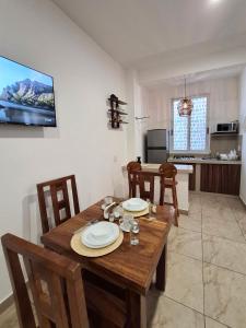 a dining room with a wooden table and chairs at Sicarú, La Punta - Puerto Escondido in Brisas de Zicatela