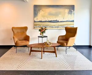 a living room with two chairs and a coffee table at Daniella's Suites in Peabody