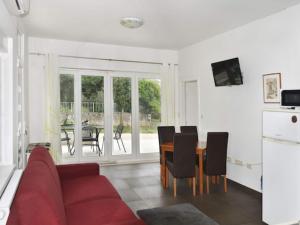 a living room with a red couch and a table at Apartments Despot Zaostrog RC in Zaostrog