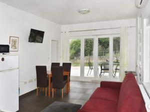 a living room with a red couch and a table at Apartments Despot Zaostrog RC in Zaostrog