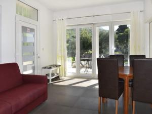 a living room with a red couch and a table at Apartments Despot Zaostrog RC in Zaostrog