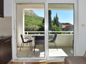 a living room with a table and chairs on a balcony at Apartments Despot Zaostrog RL in Zaostrog