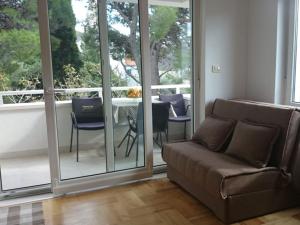 a living room with a couch and a balcony at Apartments Despot Zaostrog RL in Zaostrog +2 photos