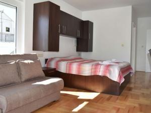 a bedroom with a bed and a couch in a room at Apartments Despot Zaostrog RL in Zaostrog