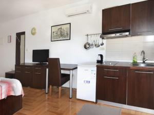 a kitchen with a desk and a table with a sink at Apartments Despot Zaostrog RL in Zaostrog
