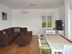 a living room with a couch and a table at Apartments Despot Zaostrog RR in Zaostrog