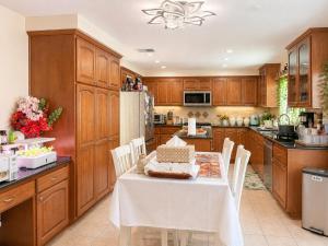 a kitchen with wooden cabinets and a table and chairs at Balloons and Wine in Murrieta