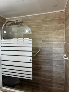 a bathroom with a shower with a glass door at Tambo Norte in San Pedro de Atacama +61 photos